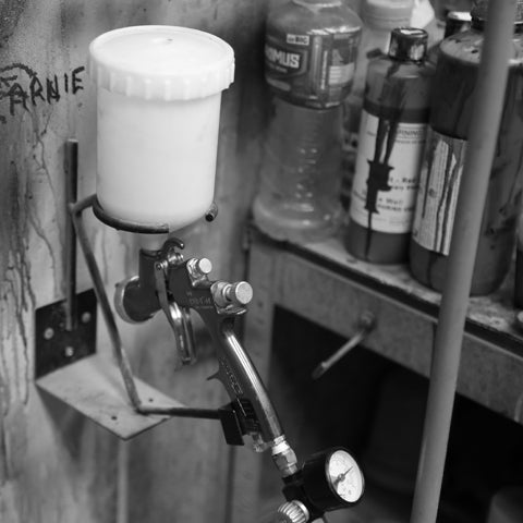 Evetts drums spray gun in the spray booth 
